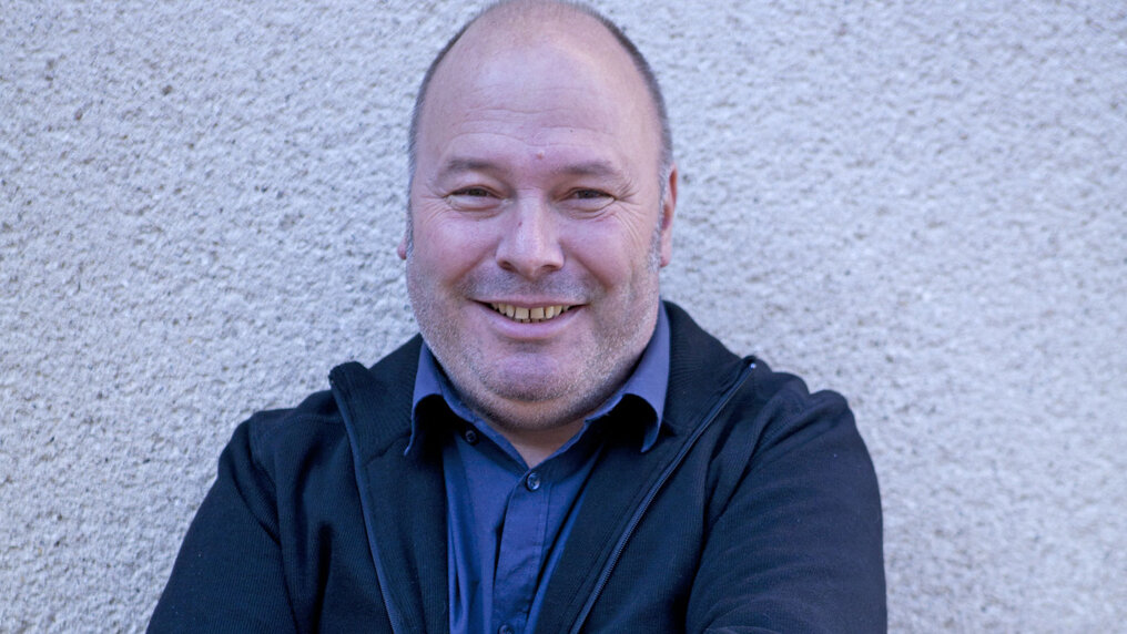 Nahaufnahme von François Servin vor einer weissen Hausmauer