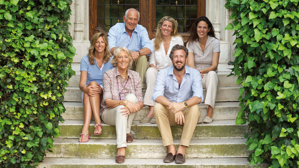 The Guerrieri Gonzaga family sits on the steps leading to the entrance of the winery building.