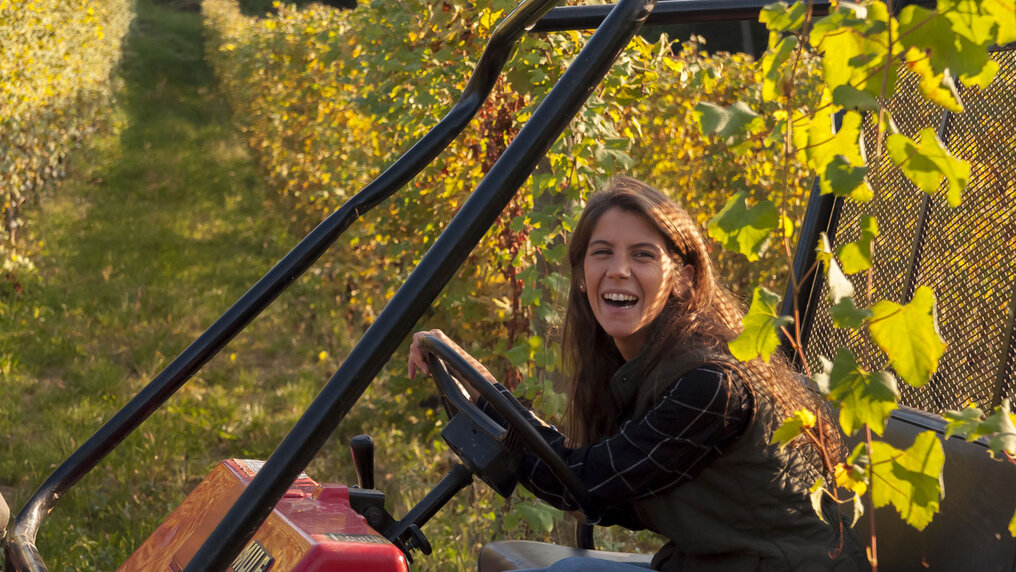 Giulia Negri drives her tractor through the vineyards.