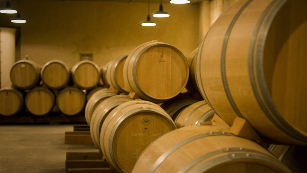 Wooden barrels in the cellar of Château Les Hauts Conseillants