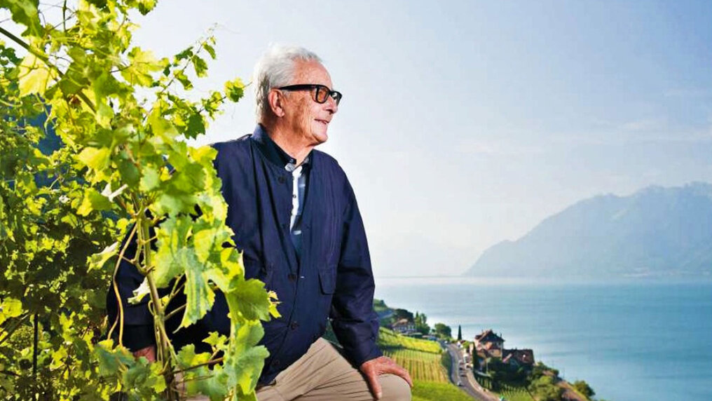 Louis Bovard stands in his vineyard and enjoys the view of Lake Geneva